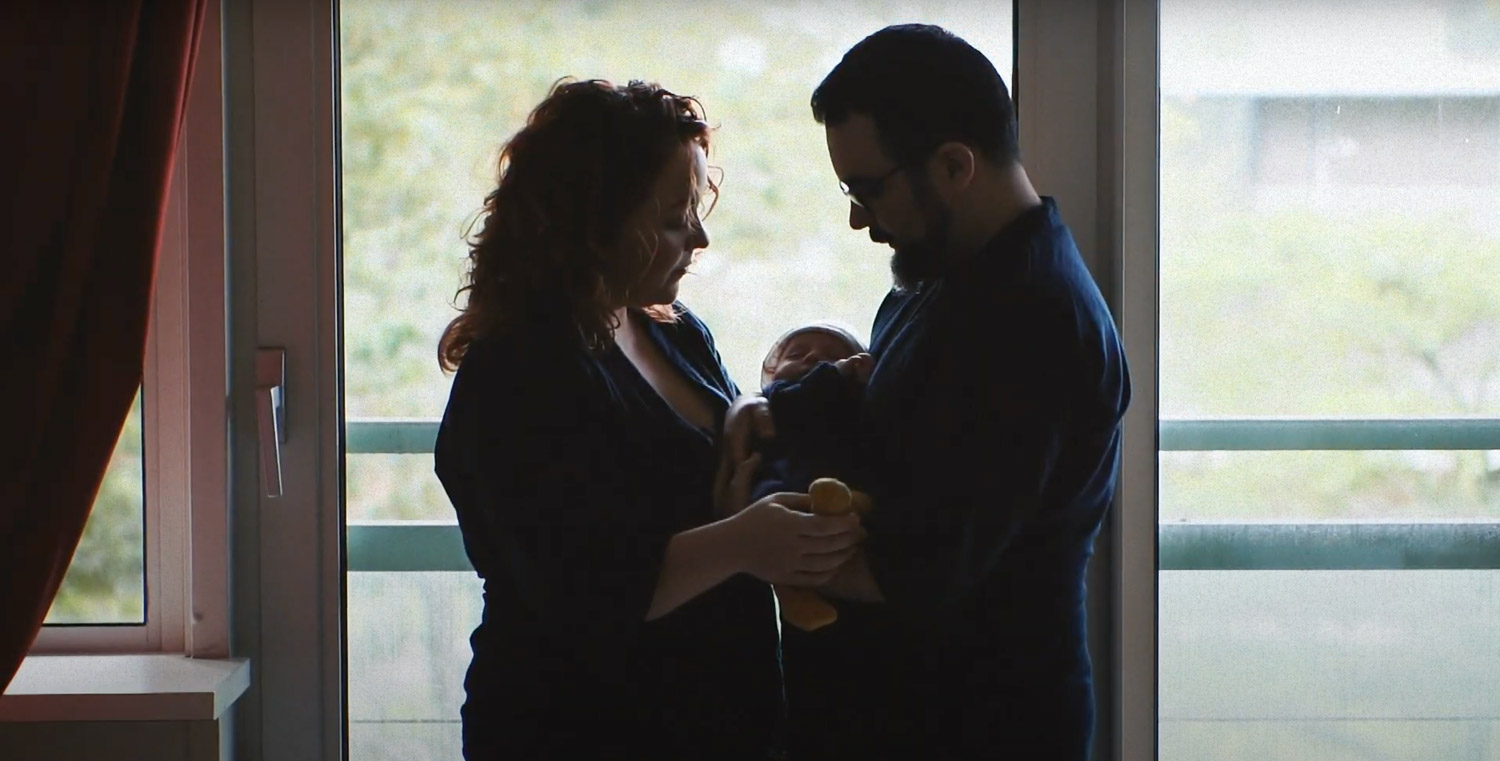 Stel met pasgeboren baby poseert voor familie videograaf Nederland