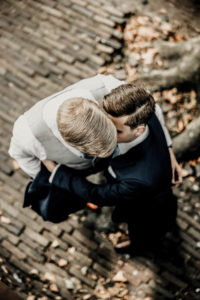 Gay couple at the gay wedding photoshoot stays and hugs. The view from up