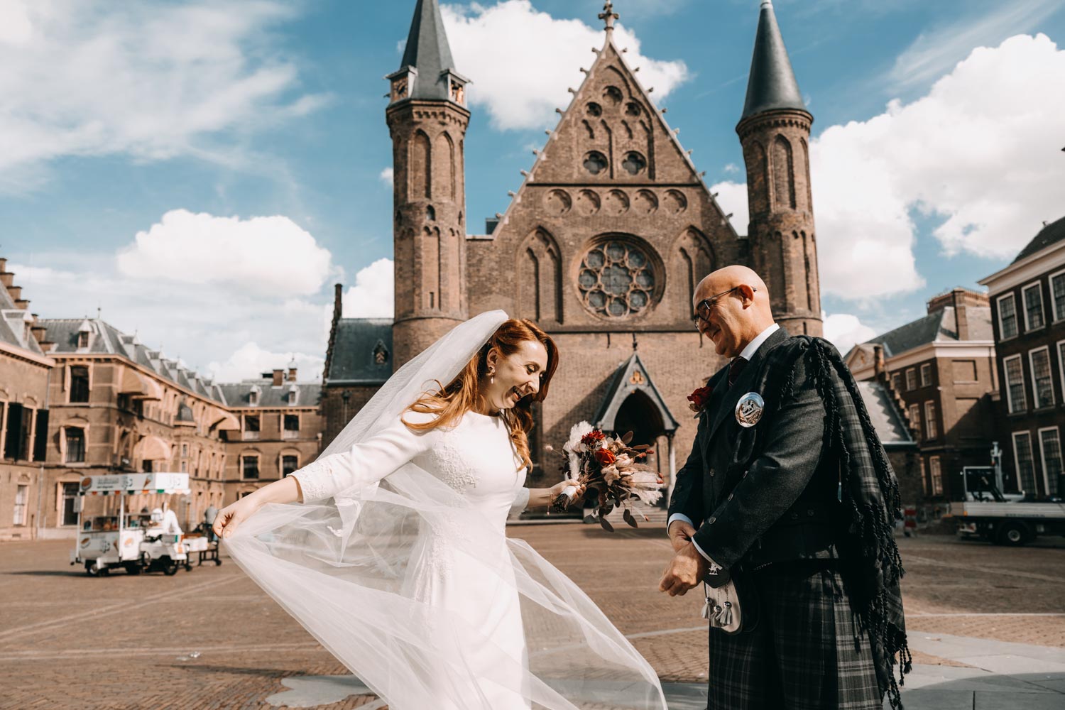 Trouwen in Den Haag. Trouwfotograaf in Den Haag. Wedding photographer in Den Haag the Hague took a photo where a bride and a groom first look before the wedding in front on Ridderzaal Binnenhof The Hague.