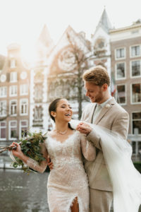 A couple smiling when photographer make photos for their wedding photoshoot in amsterdam