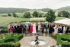 Group photo during the wedding in a castle Chateau Neercanne. Couple marry in a castle with all the family and friends