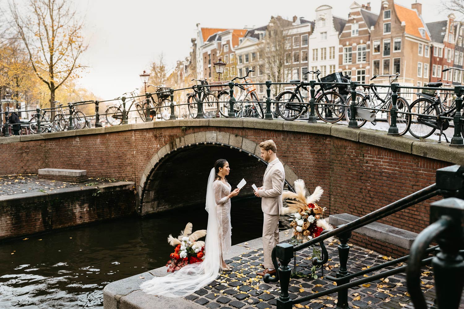 Romantic couple exchanging vows on a picturesque Amsterdam pier during their elopement ceremony. Explore our elopement packages Amsterdam for your dream intimate Amsterdam wedding