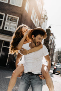 Couple's playful and carefree spirit shines in Amsterdam's charming streets during their couple photoshoot Amssterdam.
