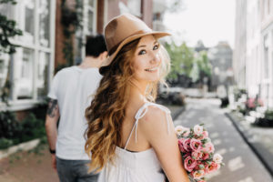 Girl on the photo looks back and smiling during their photoshoot in amsterdam. Her boyfriend chose Amsterdam proposal package to capture the moments