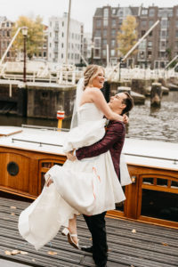 Wedding photoshoot in Amsterdam when groom liftfing up the bride and spin her around