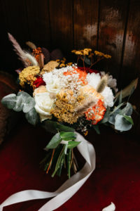 Autumn bridal bouquet with orange, red flowers