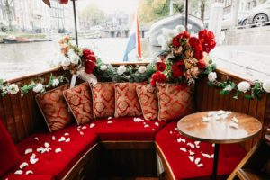 Wedding in Amsterdam on the boat with special venue decorated with flowers.