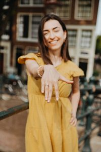Girl shows her hand with a ring after she was proposal in amsterdam. Her boyfriend hired Amsterdam proposal package to capture this moment