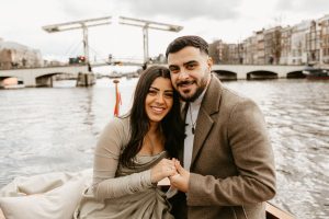 Amsterdam engagement photoshoot , where couple posing to a photographer in front of Skinny bridge