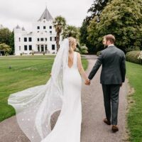 Bride and groom walking through the gardens of Landgoed Sandenburg captured by a professional photographer in Amsterdam