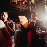 Guests celebrating on the dance floor during a wedding reception captured by a professional photographer in Amsterdam